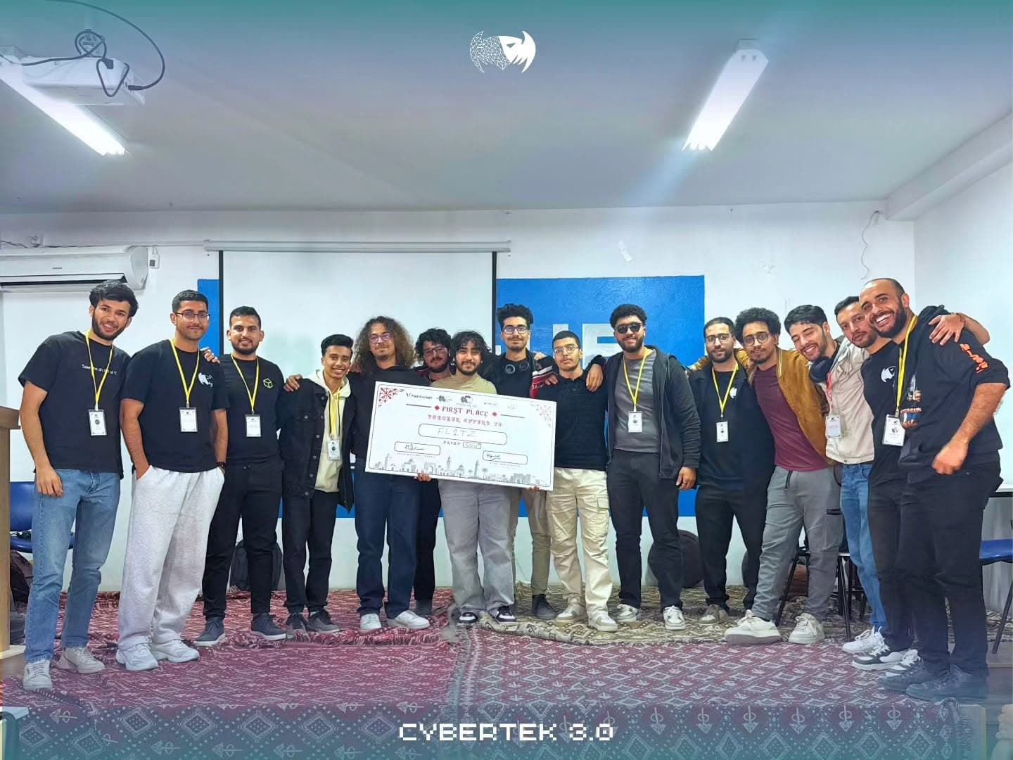 The winning team holding their prize on stage